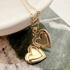 A romantic and timeless locket in a modern, dainty silhouette. The functional heart locket hangs upon a delicately twisted chain. Versatile enough to simply be worn solo or layered as the perfect compliment to your favorite necklaces. Adjustable between 18-21". Locket measures 1/2". Our materials make for an amazing, high quality, seamless, jewelry piece with longevity. Our necklaces are plated with 18k gold, 18k rose gold, or rhodium and finished with a protective coating. A little secret we’ll Golden Locket, Gold Locket Necklace, Twisted Chain, Bar Pendant Necklace, Heart Locket Necklace, Daisy Necklace, Rose Quartz Necklace, Gold Locket, Initial Pendant Necklace