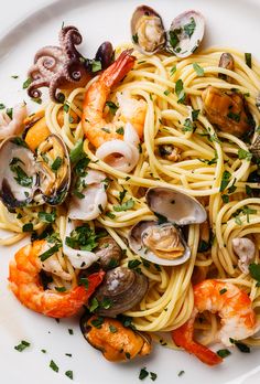 pasta with shrimp, clams and parsley on a white plate stock photo - 779