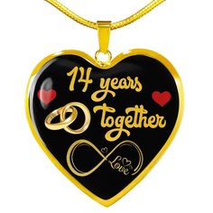 a black and gold heart shaped necklace with the words 39 years together