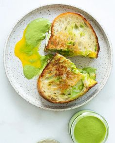 two pieces of toast on a plate with green sauce