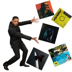 a man in a black suit is surrounded by pictures and photos on the floor with his hands out