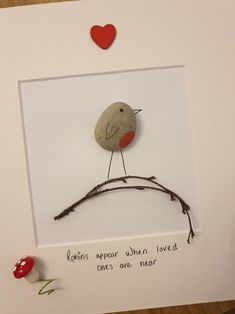 a card with a bird sitting on top of a branch next to a red heart