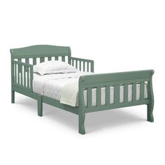 a green bed frame with white sheets on it