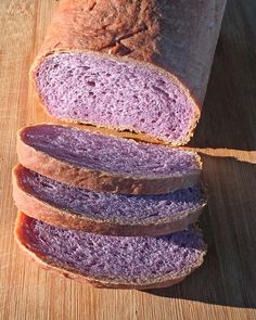 a loaf of bread sitting on top of a wooden cutting board