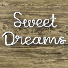 the word sweet dreams written in white yarn