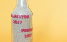 a bottle that has some kind of message on it in front of a yellow background