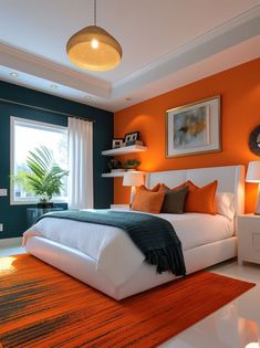 a bedroom with orange and blue walls, white bedding, and an area rug