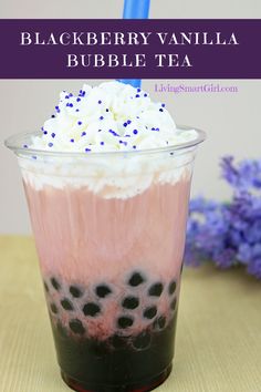 a drink with whipped cream and blueberries in it