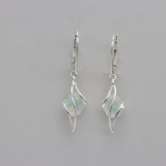 These is a pair of beautiful Earrings with lab created Fire Opal.  The earrings are made out of solid 925 Silver and there is no nickel or other substances causing most allergies. This makes the earrings hypo allergenic. Size of one Earring in total  4.0 x 1.0 cm / 1.57 x 0.39 inch The hooks are 1.8 cm or about 3/4 inch long. You will receive the item in a gift box - perfect to surprise someone or yourself. Usually we ship on the same day we receive the payment for the order. We want you to be h Silver Opal Dangle Jewelry, Silver Opal Earrings, Elegant Silver Opal Earrings, Handmade Opal Earrings In Silver, Adjustable Nickel-free Opal Earrings, Pretty Earrings, White Opal, Star Earrings, Fire Opal