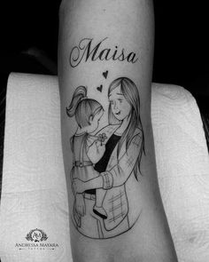 a woman holding a child with the word maisa on her arm