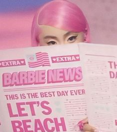 a woman with pink hair is holding up a news paper and reading it in front of her face