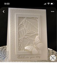 a white card with a butterfly on it