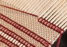 a close up view of a red and white striped fabric on a piece of cloth