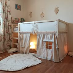 there is a bunk bed with curtains on the top and bottom, next to a lamp