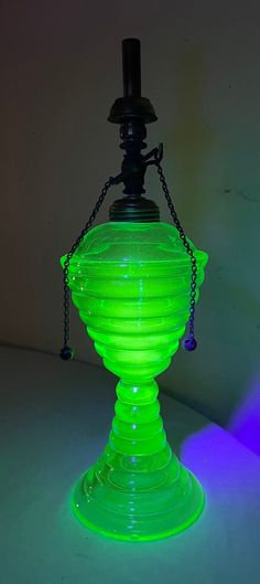 a green light that is on top of a white table with a chain around it