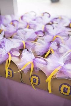 several boxes with purple and yellow ribbons on them