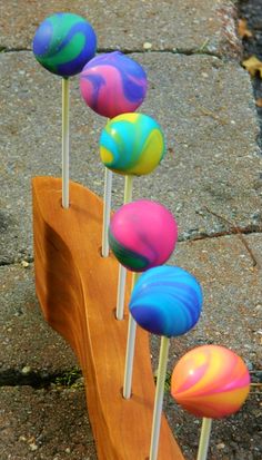 there are many lollipops that are on the wooden stick stand in the street