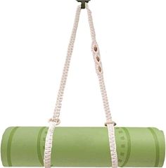 a green yoga mat hanging from a hook