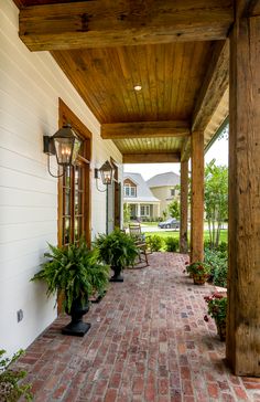 the walkway is lined with potted plants on either side of the house and between two buildings