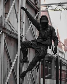 a man climbing up the side of a metal structure with his feet in the air