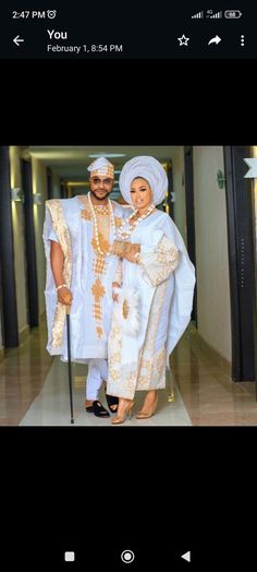 a man and woman dressed in white standing next to each other