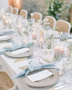 a table set with place settings and candles