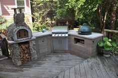 an outdoor bbq and grill on a deck