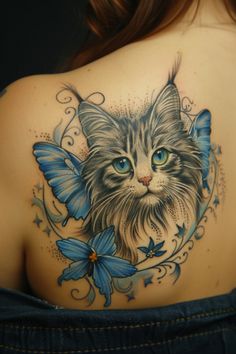 a woman's back with a cat and butterfly tattoo on her left shoulder,