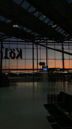 the inside of an airport terminal at sunset