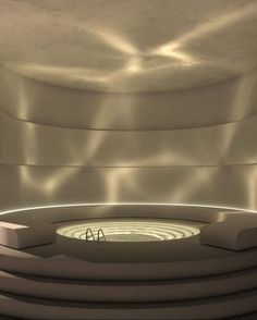 a circular room with light coming in from the ceiling