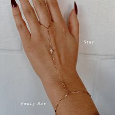 The Slayer Girl Hand Chain is the perfect customized hand chain that gives off the ultimate sparkle. Add a charm to your hand chain to create a piece that is custom made for YOU just like you're in our store in Scottsdale, AZ! Product Details: Made to Order - FINAL SALE 14K Gold-Filled Starburst, Rope or Fancy Bar chain Gothic Initials, Birthstones, CZ Star, Flower & Roman Cross Charms Available 6", 7", 8" Wrist Sizes Available 3" Ring Circumference with 3.5" Connecting Chain Water-Wearable Made Aesthetic Hand Jewelry, Permanent Hand Chain, Hand Chain Jewelry Gold, Fancy Bar, Chains Aesthetic, Hand Chain Jewelry, Finger Bracelets, Gold Bracelet Simple, Hand Chain Bracelet