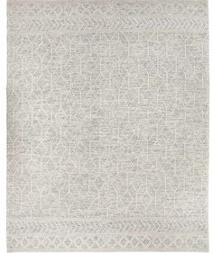 a gray and white rug with an intricate design on the bottom, in front of a white background