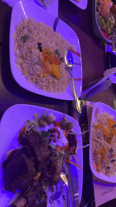 several plates of food on a table with utensils