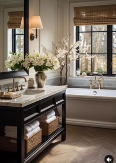 a bathroom with a tub, sink, and window in the background that has white flowers on it