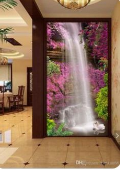 an open door with a waterfall and pink flowers on the outside, in front of a dining room