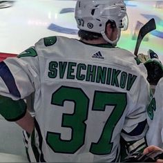 two hockey players standing next to each other