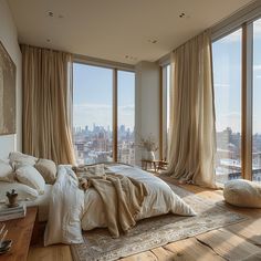 a bedroom with large windows and a view of the city