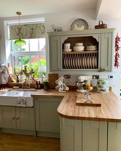 a kitchen filled with lots of counter top space and wooden counters next to a window