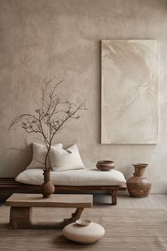 a living room with a couch, table and vases on the floor next to it