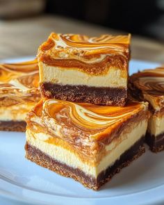 four pieces of cake sitting on top of a white plate with chocolate and caramel swirl