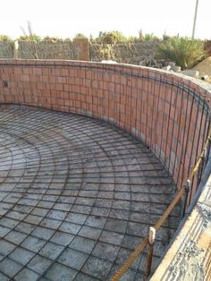 a brick wall is being constructed into a circular area