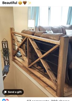 a couch sitting on top of a wooden shelf next to a window