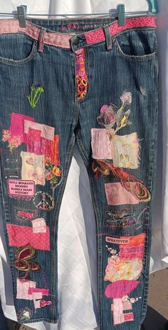 a pair of jeans that have been decorated with different colored patches and designs on them