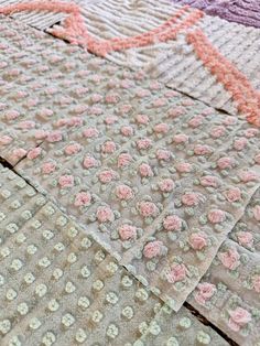 several pieces of fabric with pink and white flowers on them are laid out in rows