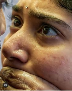 a close up of a man with his hand on his face