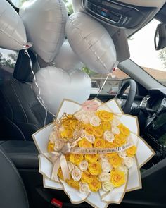 a bunch of balloons in the back seat of a car with a bouquet on it