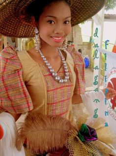 a woman wearing a large hat and dress