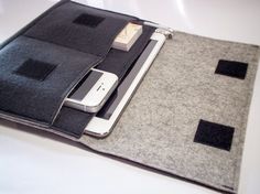 an ipad case is sitting on top of a table with a cell phone in it