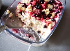 a glass dish filled with fruit and ice cream