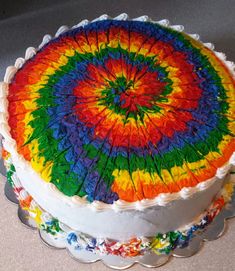 a multicolored cake sitting on top of a table